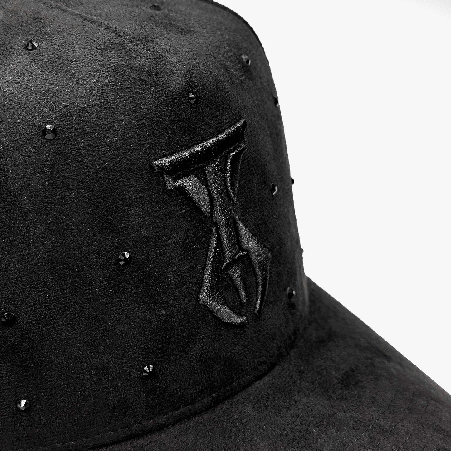 Close-up of TX Starlight Smoke Edition hat showing intricate black-on-black embroidery and crystal accents