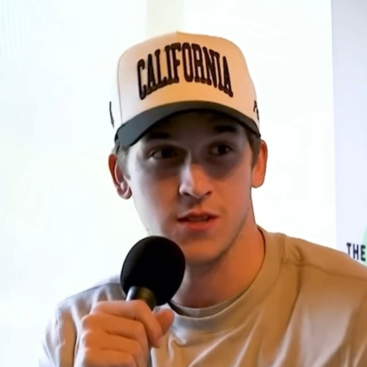 Model Wearing California Off White Snapback – Close-Up Indoor Portrait with Glasses