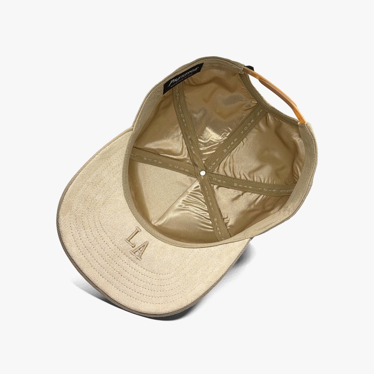 Louisiana sand 5 panel snapback interior showing satin lining, suede under brim, under brim embroidery and Wear Your Story tape