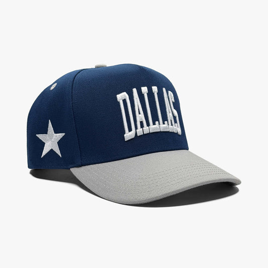 Side view of navy Dallas snapback hat showing grey brim and Prestige Collection embroidery
