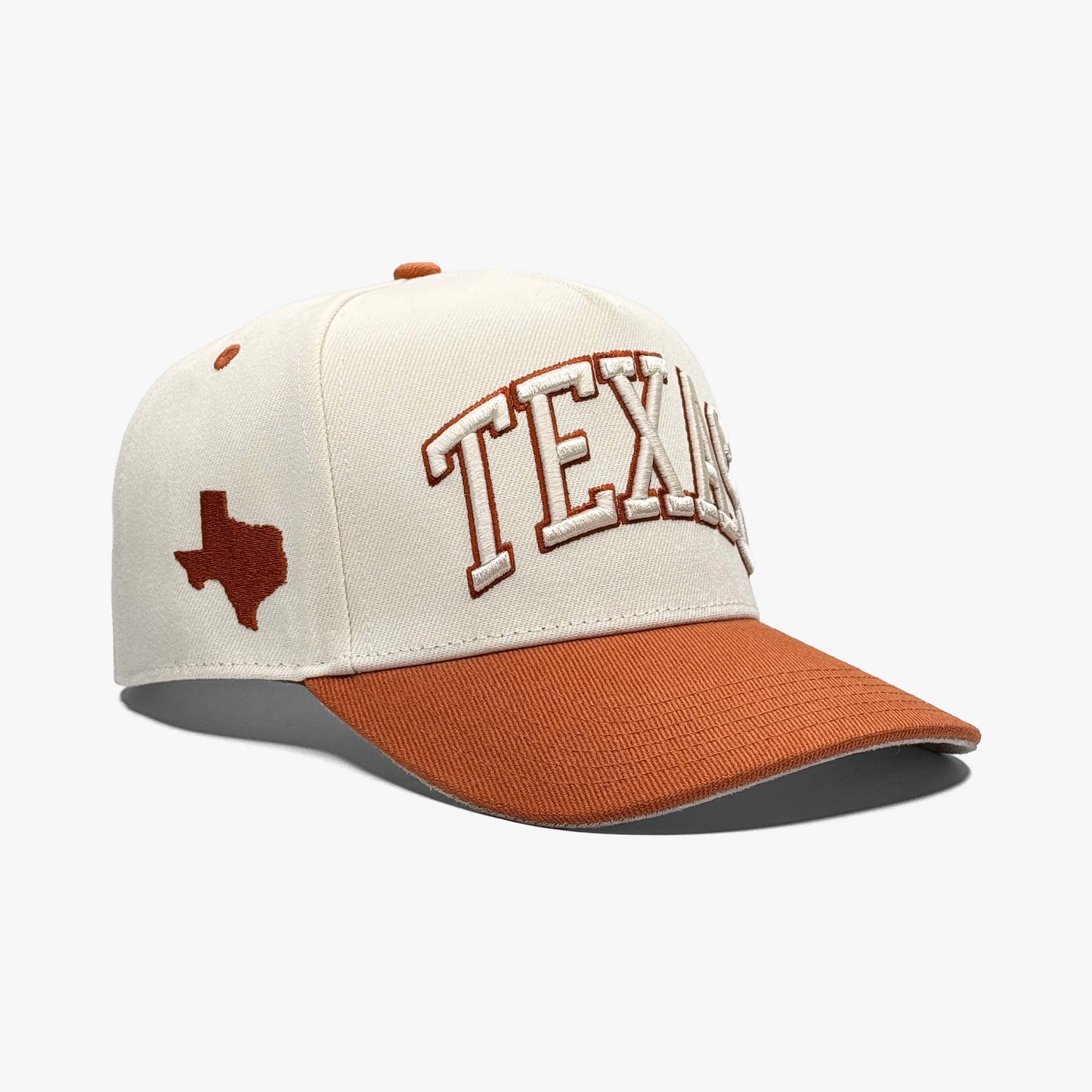 Side view of cream Texas snapback hat showing burnt orange brim and Texas state outline embroidery