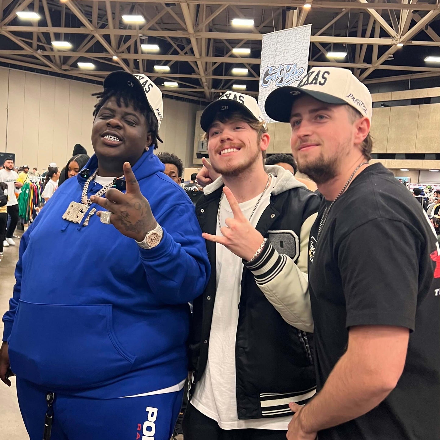 Model Wearing Texas Off White Snapback – Event Shot with Prestige Collection Booth